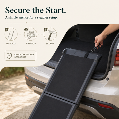 Black pet ramp securing strap and hook setup at vehicle