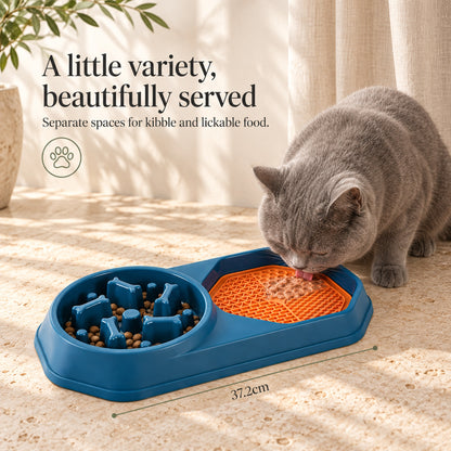 Cat using the orange licking mat beside the slow feeder bowl